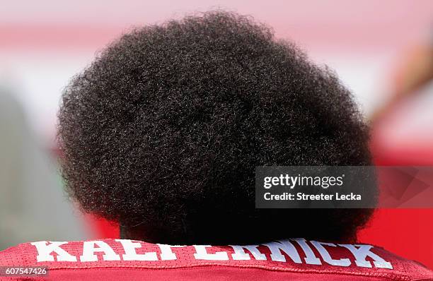 Colin Kaepernick of the San Francisco 49ers kneels during the national anthem before their game against the Carolina Panthers at Bank of America...