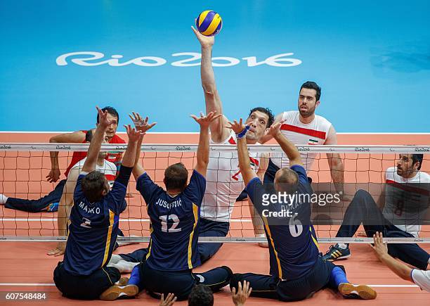 Morteza Mehrzadselakjani IRI jumps for the ball at their Men's Gold Medal Match against Bosnia of Sitting Volleyball at the Riocentro - Pavilion 6...