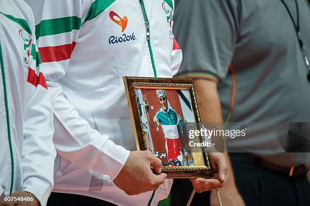 An IR Iran's player holds a portrait of Para cyclist Bahman Golbarnezhad IRI who died competing the previous day, at their Men's Gold Medal Match...