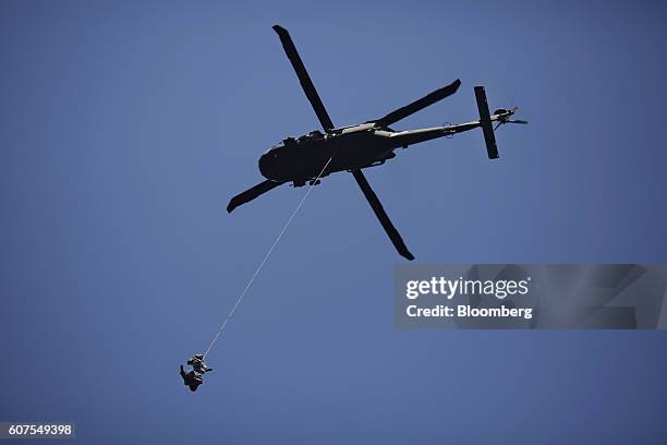 Members of the Kentucky State Police Cannabis Suppression Branch are hoisted by a Kentucky National Guard UH-60 Blackhawk helicopter after...