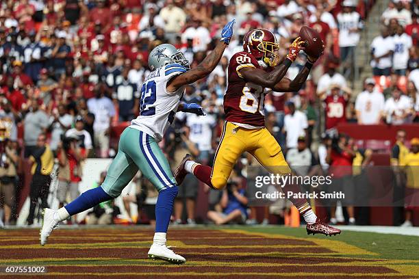 Wide receiver Jamison Crowder of the Washington Redskins scores a third quarter touchdown past cornerback Orlando Scandrick of the Dallas Cowboys at...