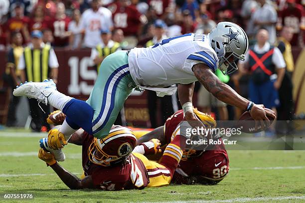 Quarterback Dak Prescott of the Dallas Cowboys scores a third quarter touchdown past inside linebacker Mason Foster of the Washington Redskins at...