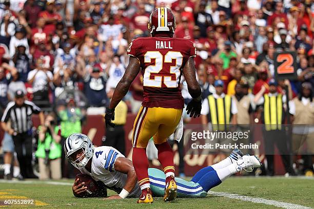 Quarterback Dak Prescott of the Dallas Cowboys scores a third quarter touchdown past free safety DeAngelo Hall of the Washington Redskins at...