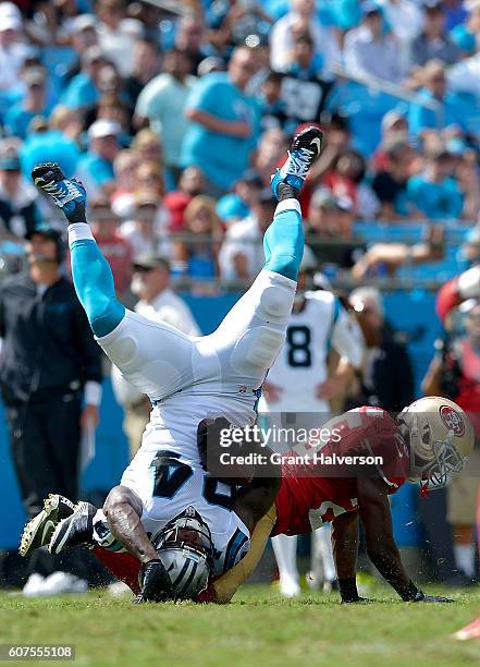 Jimmie Ward of the San Francisco 49ers tackles Ed Dickson of the Carolina Panthers in the 3rd quarter during the game at Bank of America Stadium on...