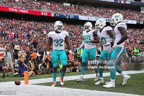 Kenyan Drake of the Miami Dolphins celebrates with teammates after scoring a touchdown during the fourth quarter against the New England Patriots at...