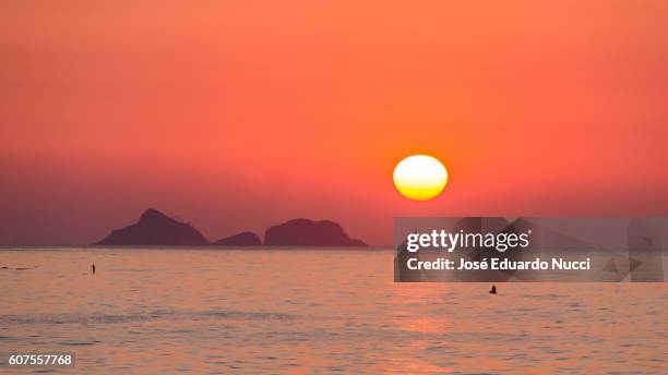 sunset , ipanema beach, rio de janeiro - arpoador beach stock-fotos und bilder