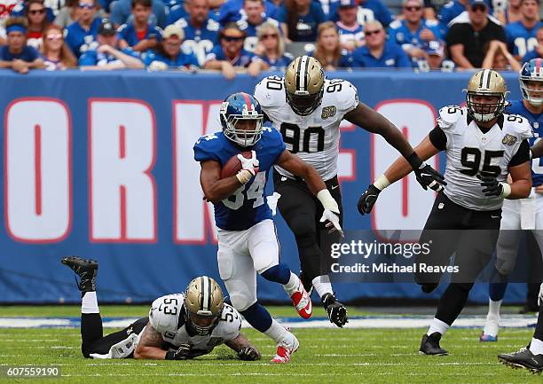 Shane Vereen of the New York Giants rushes against James Laurinaitis, Nick Fairley and Tyeler Davison of the New Orleans Saints during the first half...