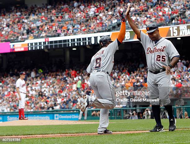Justin Upton of the Detroit Tigers celebrates with Third Base Coach Dave Clark after hitting a two run home run against the Cleveland Indians in the...