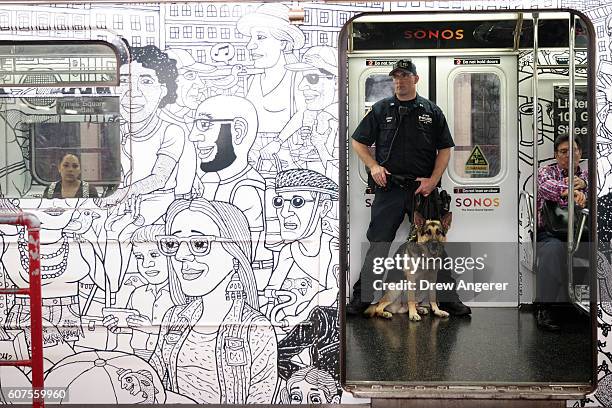 Member of the New York City Police Department K-9 Unit patrols on a subway train between Grand Central Terminal and Times Square, September 18, 2016...