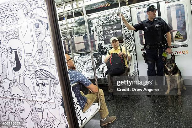 Member of the New York City Police Department K-9 Unit patrols on a subway train between Grand Central Terminal and Times Square, September 18, 2016...