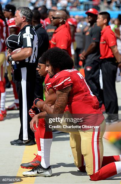 San Francisco 49ers quarterback Colin Kaepernick, front, and safety Eric Reid, back left, kneel during the playing of the national anthem on Sunday,...