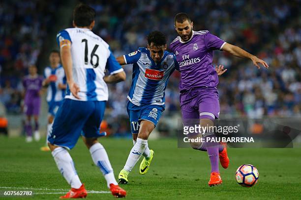 Real Madrid's French forward Karim Benzema vies with Espanol's Paraguayan midfielder Hernan Perez during the Spanish league football match RCD...
