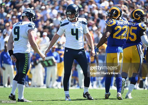 Steven Hauschka of the Seattle Seahawks celebrates his field goal with teammate Jon Ryan during the second quarter of the home opening NFL game...