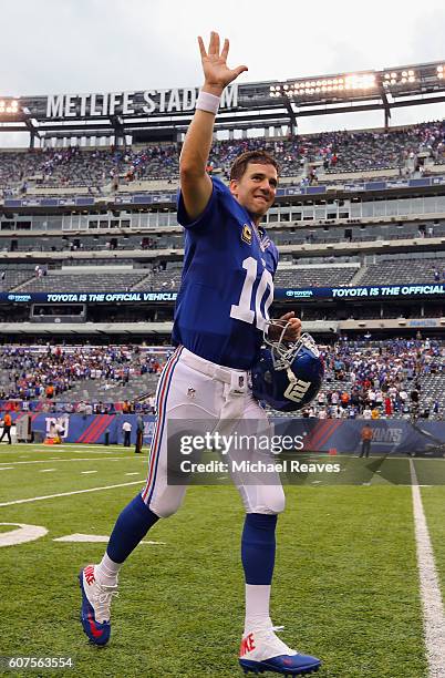 Quarterback Eli Manning of the New York Giants leaves the field after their 16-13 win over the New Orleans Saints during the second half at MetLife...