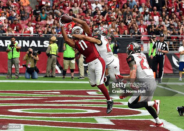 Wide receiver Larry Fitzgerald of the Arizona Cardinals makes a catch for a touchdown over cornerback Brent Grimes of the Tampa Bay Buccaneers during...