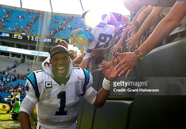 Cam Newton of the Carolina Panthers high fives fans after their 46-27 victory over the San Francisco 49ers at Bank of America Stadium on September...