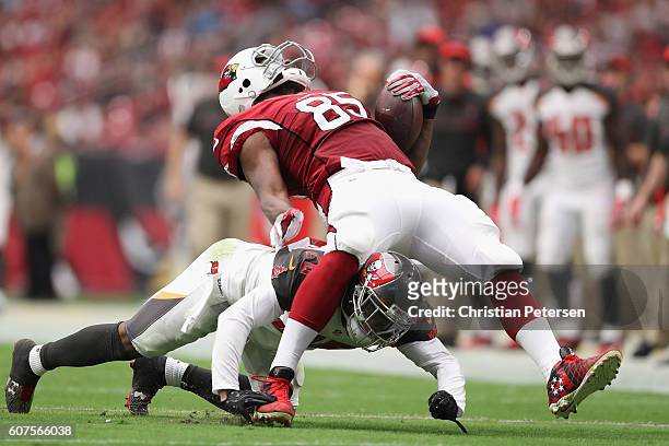 Tight end Darren Fells of the Arizona Cardinals is hit by cornerback Vernon Hargreaves of the Tampa Bay Buccaneers during the second quarter of the...