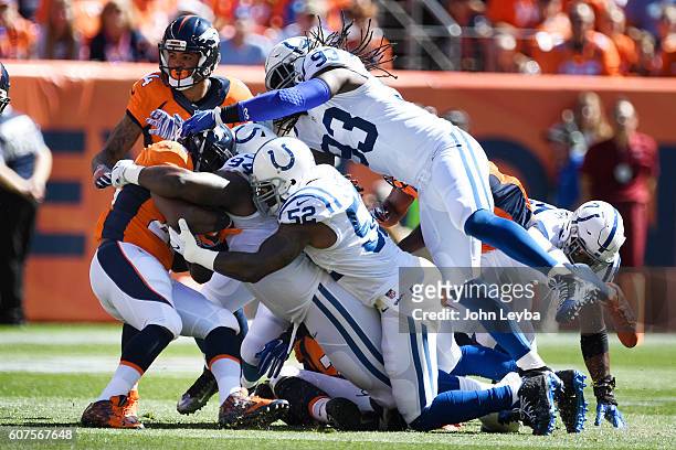 Anderson of the Denver Broncos is gang tackled by Zach Kerr of the Indianapolis Colts, D'Qwell Jackson and Erik Walden during the first quarter. The...