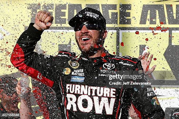 Martin Truex Jr, driver of the Furniture Row/Denver Mattress Toyota, celebrates in Victory Lane after winning the NASCAR Sprint Cup Series Teenage...