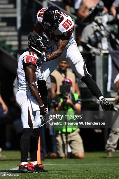 Julio Jones of the Atlanta Falcons celebrates with Levine Toilolo after a 21-yard touchdown against the Oakland Raiders during their NFL game at...