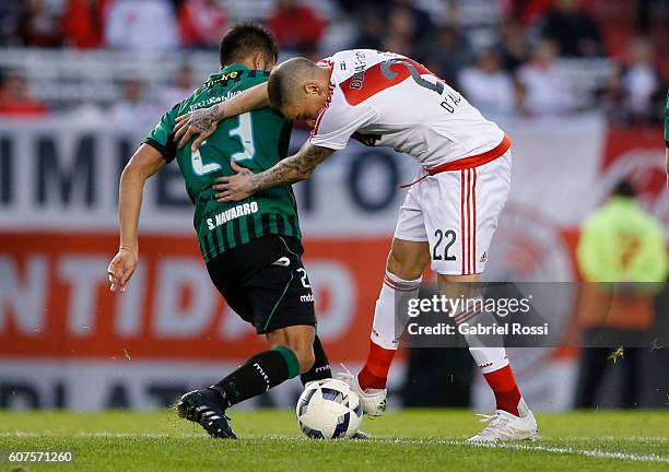 Andres D'Alessandro of River Plate fights for the ball with Sebastian Navarro of San Martin during a match between River Plate and San Martin as part...