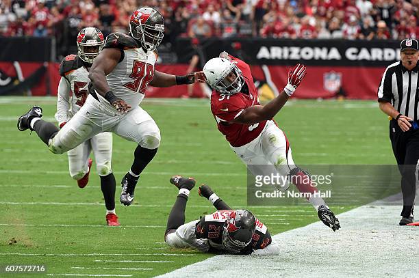 Running back David Johnson of the Arizona Cardinals is pushed out of bounds by defensive end Clinton McDonald and cornerback Vernon Hargreaves III of...
