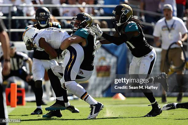 Tashaun Gipson, Paul Posluszny and Davon House of the Jacksonville Jaguars try to stop Tyrell Williams of the San Diego Chargers on his way to a...