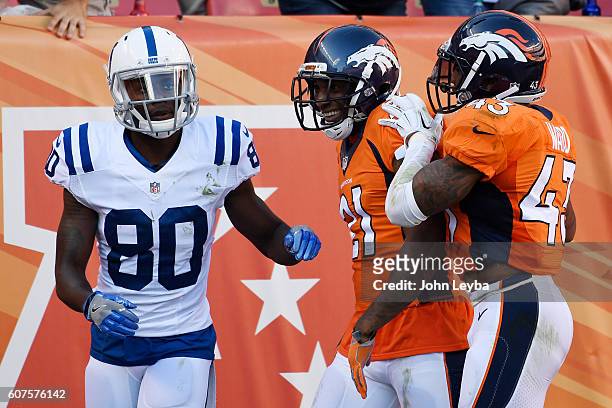 Aqib Talib of the Denver Broncos celebrates his pick-six on a ball thrown by Andrew Luck of the Indianapolis Colts intended for Phillip Dorsett with...