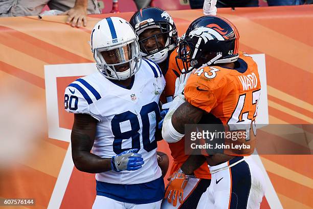 Aqib Talib of the Denver Broncos celebrates his pick-six on a ball thrown by Andrew Luck of the Indianapolis Colts intended for Phillip Dorsett with...