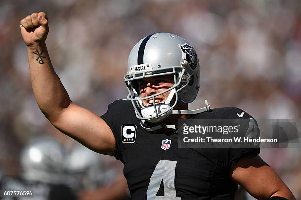 Derek Carr of the Oakland Raiders celebrates after a two-yard touchdown pass against the Atlanta Falcons during their NFL game at Oakland-Alameda...
