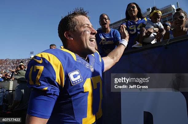 Quarterback Case Keenum of the Los Angeles Rams high fives fans as he leaves the field after his team's 9-3 victory over the Seattle Seahawks in the...