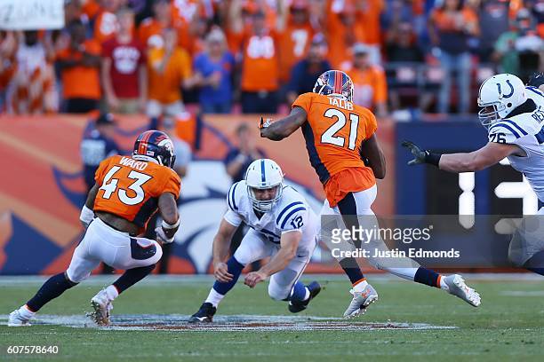 Cornerback Aqib Talib of the Denver Broncos intercepts a ball intended for wide receiver Phillip Dorsett and dodges quarterback Andrew Luck of the...