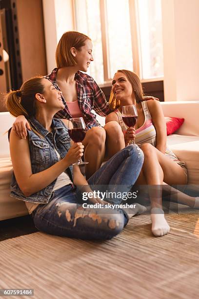 happy female friends drinking wine and laughing at home. - girls' night in stock pictures, royalty-free photos & images