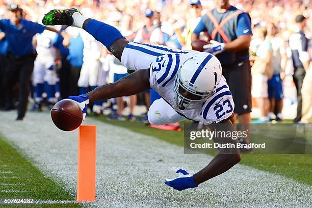 Running back Frank Gore of the Indianapolis Colts scores a touchdown in the fourth quarter of the game against the Denver Broncos at Sports Authority...