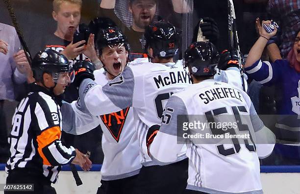 Jack Eichel of Team North America celebrates his goal at 5:03 of the first period against Team Finland and is joined by Connor McDavid and Mark...