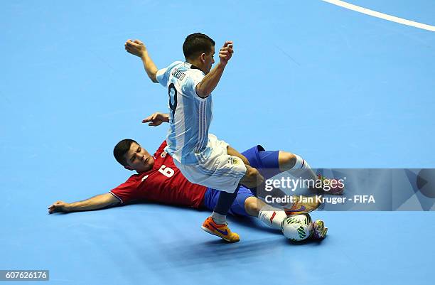 Victor Fonseca of Costa Rica slides to tackle Cristian Borruto of Argentina during the FIFA Futsal World Cup Group E match between Costa Rica and...