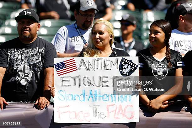 Fan holds a sign in the stands in reference to national anthem protests by players prior to the NFL game between the Oakland Raiders and the Atlanta...