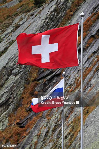 swiss and russian flags at suvorov memorial - switzerland flag stock pictures, royalty-free photos & images