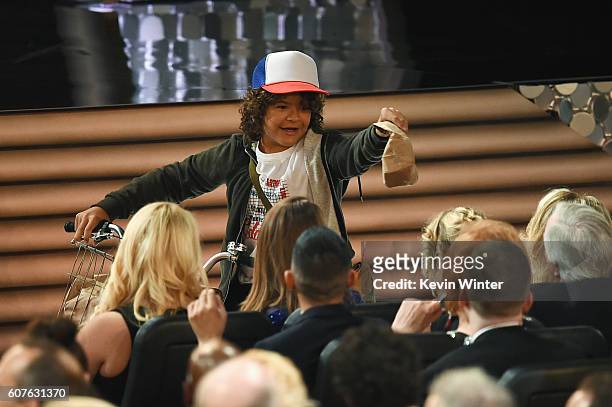 Actor Gaten Matarazzo passes out peanut butter and jelly sandwiches to the audience during the 68th Annual Primetime Emmy Awards at Microsoft Theater...