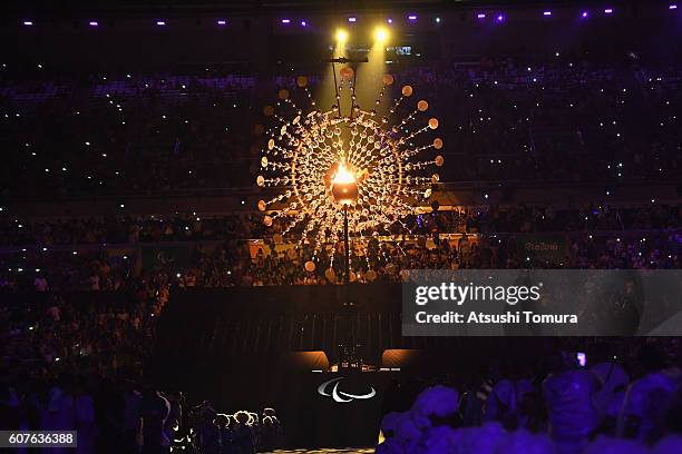 The flame is lowered prior to being extinguished during the closing ceremony of the Rio 2016 Paralympic Games at Maracana Stadium on September 18,...