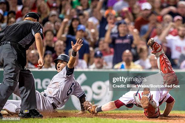 Mason Williams of the New York Yankees is safe against the tag of Bryan Holaday of the Boston Red Sox during the fourth inning of a game on September...