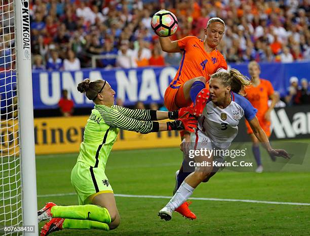 Allie Long scores a goal off a header against Mandy van den Berg and goalkeeper Sari van Veenendall of the Netherlands at Georgia Dome on September...