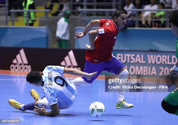 Cristian Borruto of Argentina falls to the floor as Juan Cordero of Costa Rica paces the ball during Group E match play between Costa Rica and...