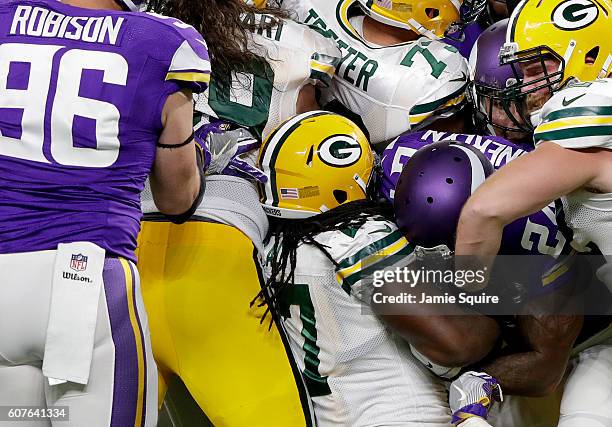 Eddie Lacy of the Green Bay Packers is tackled by the Minnesota Vikings in the first half of their game on September 18, 2016 at US Bank Stadium in...