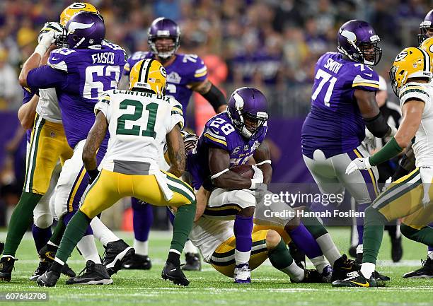 Adrian Peterson of the Minnesota Vikings is tackled by Kyler Fackrell of the Green Bay Packers in the third quarter of their game on September 18,...