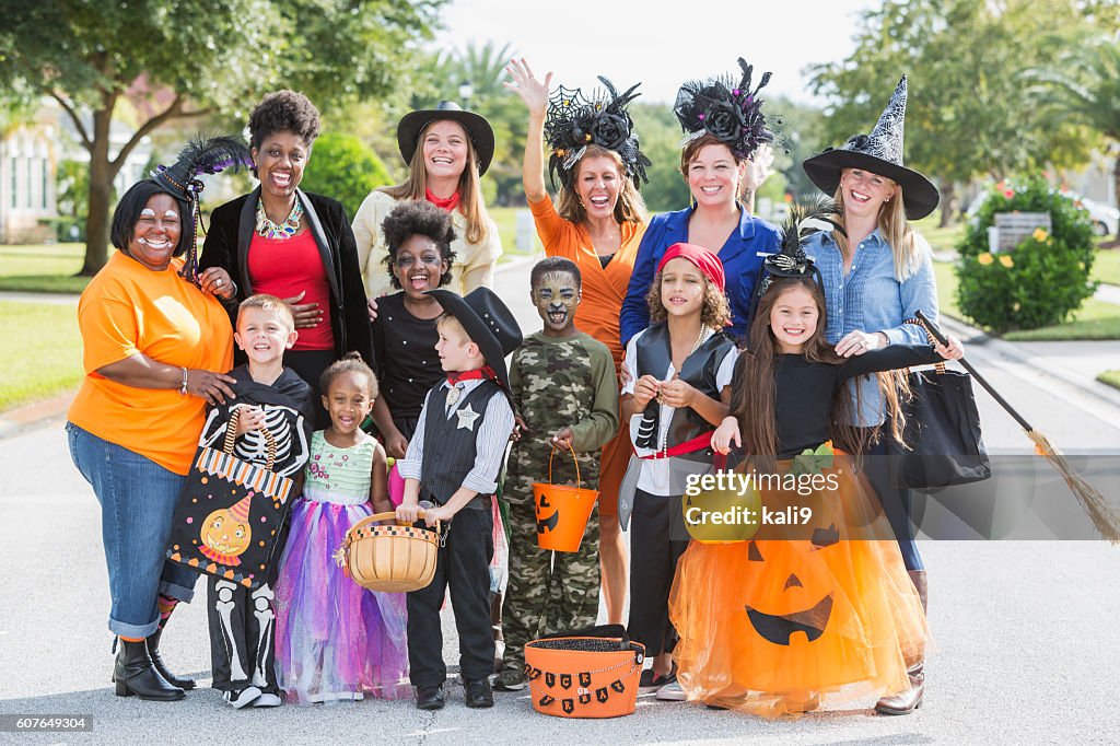 Group of women with children in halloween costumes