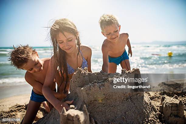 kids  building a sandcastle on beautiful beach - sand castle bildbanksfoton och bilder