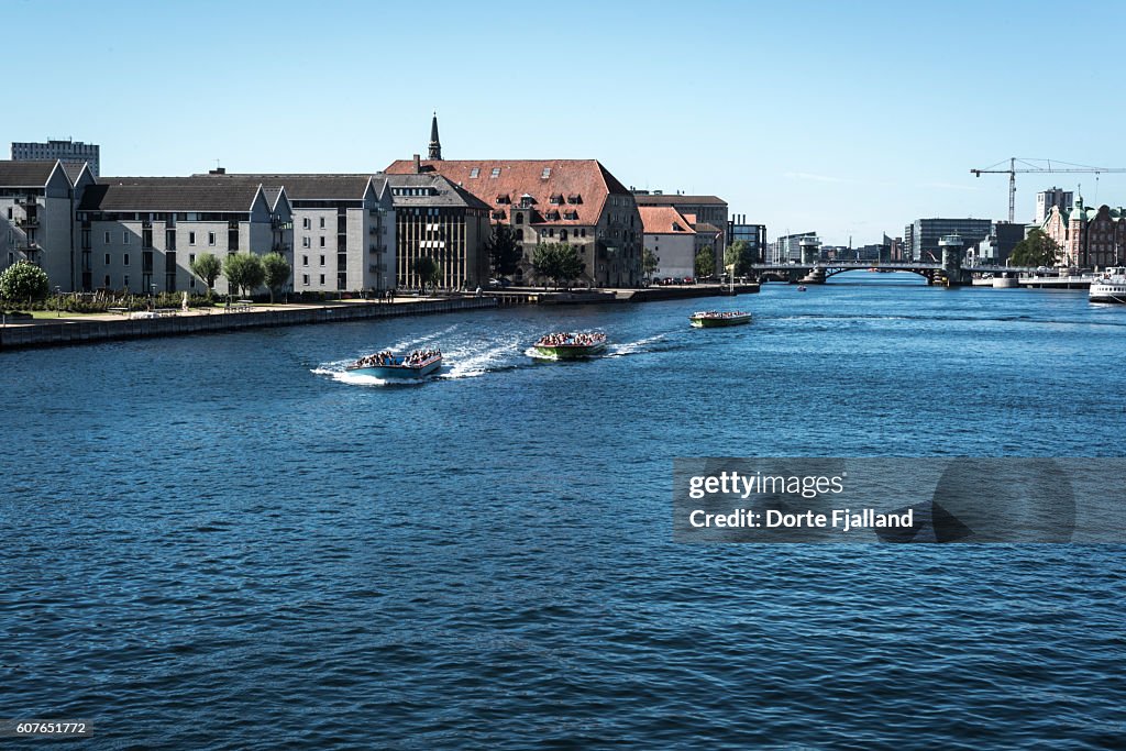 Three canal tour boats in Copenhagen Harbour