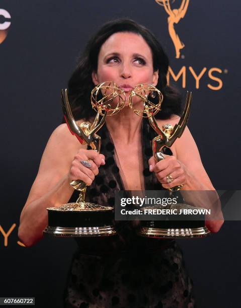 Actress Julia Louis-Dreyfus poses with the Emmys for Outstanding Comedy Series and Oustanding Lead Actress in a Comedy Series, in the press room...