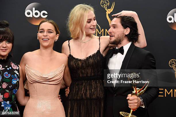Actors Maisie Williams, Emilia Clarke, Sophie Turner and Kit Harington, winners of Best Drama Series for "Game of Thrones", pose in the press room...